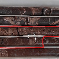 AL17-001_79.30-82.18	“Minas Nuevas vein zone.  Red outline shows sample Interval 80.45-81.45 m, assaying 279 g/t Ag.  Silver appears to be concentrated in dark grey fragments in breccia (blue arrows).”